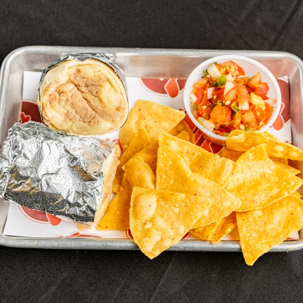 BTB Burrito meal with a burrito, tortilla chips, and a side of fresh salsa on a tray.