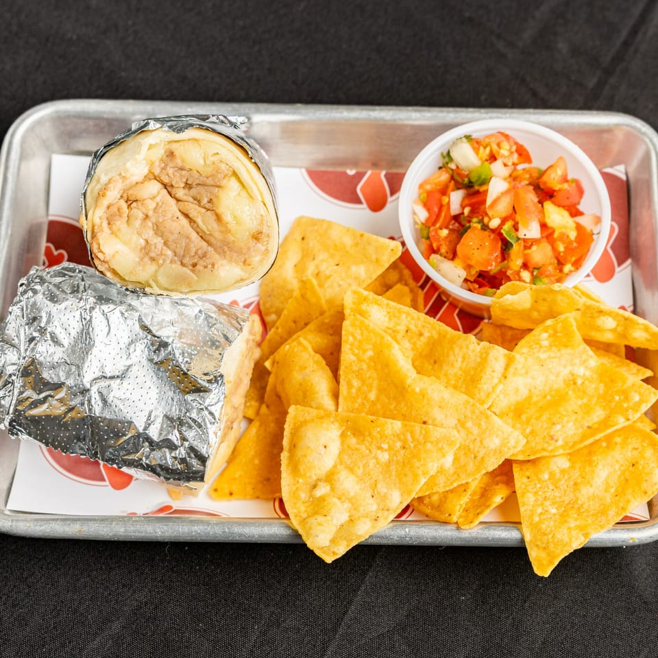 BTB Burrito meal with a burrito, tortilla chips, and a side of fresh salsa on a tray.